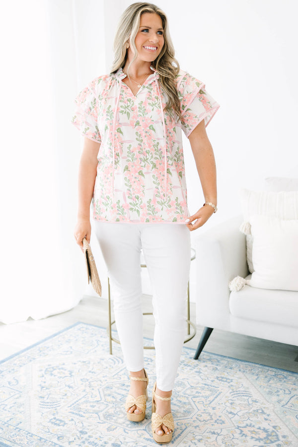 Plus Size pink and green floral print top with ruffled short sleeves and a tie-neckline.