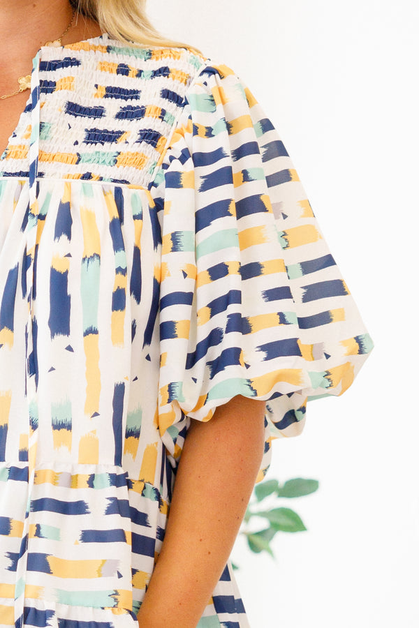 Chic Soul Plus size clothing, blue baby doll top with and muti-color blue and yellow abstract pattern and bubble sleeves 
