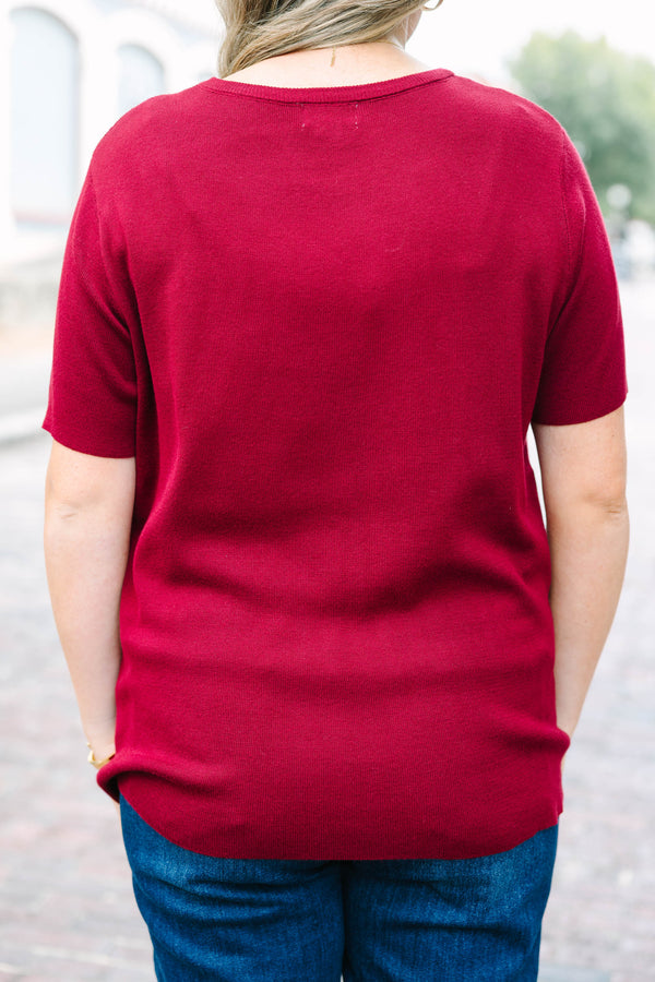Plus Size burgundy short sleeve knit sweater with a round neckline and relaxed fit.