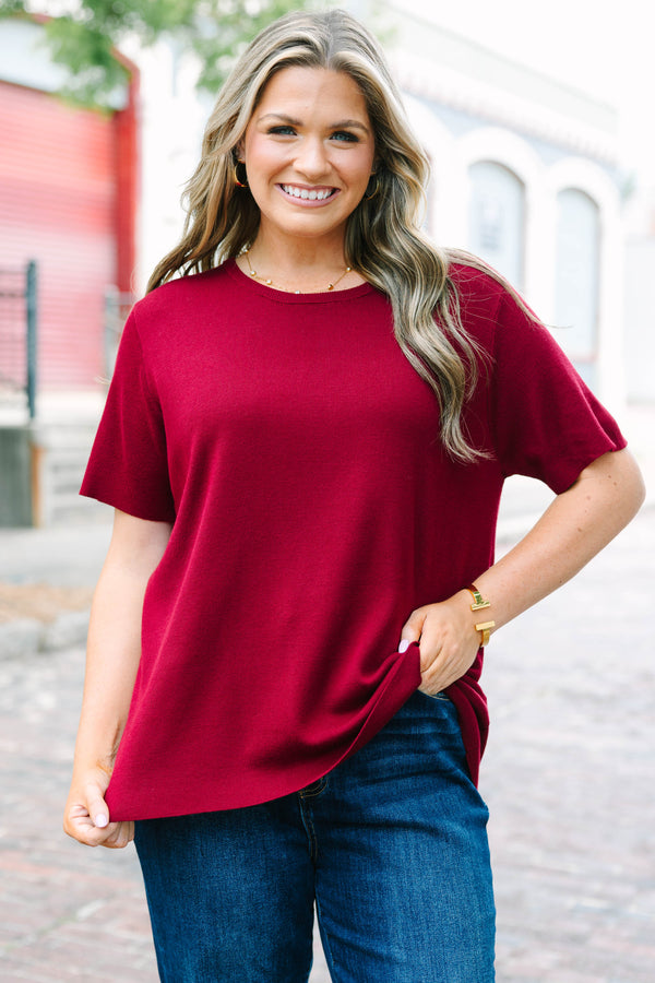 Plus Size burgundy short sleeve knit sweater with a round neckline and relaxed fit.