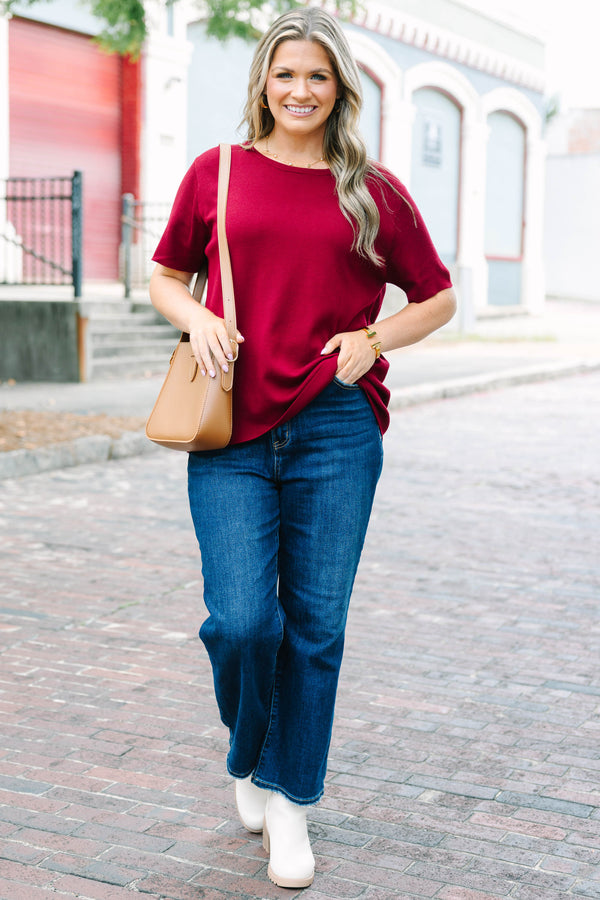 Plus Size burgundy short sleeve knit sweater with a round neckline and relaxed fit.