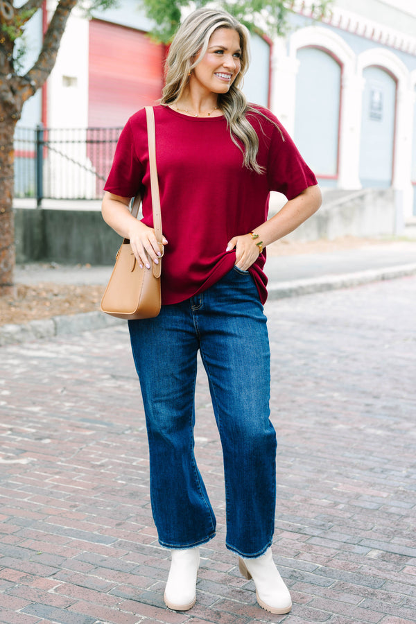 Plus Size burgundy short sleeve knit sweater with a round neckline and relaxed fit.