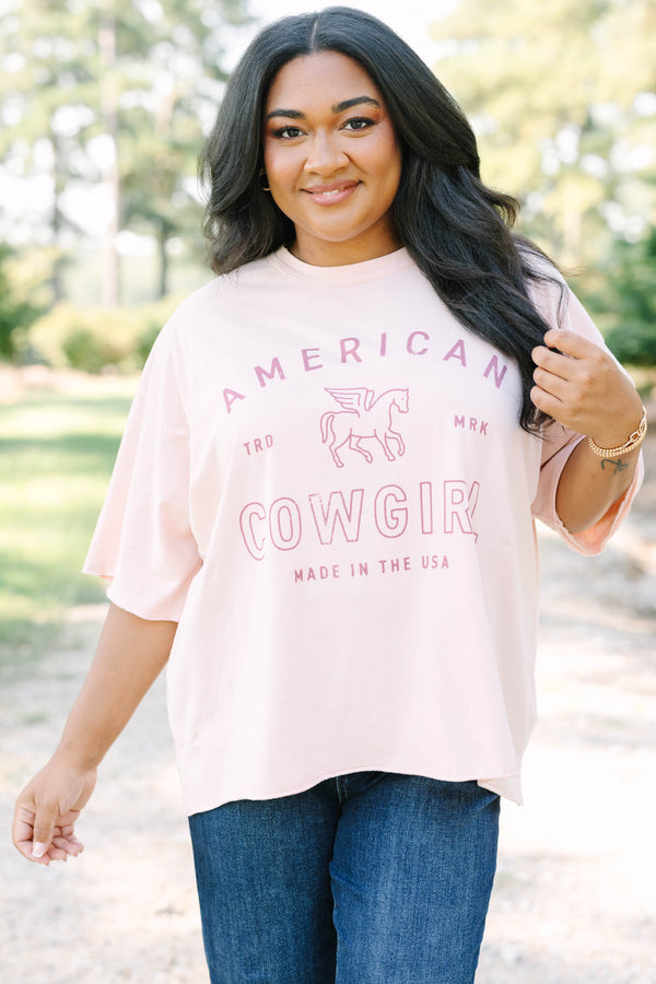 Plus Size blush pink vintage wash tee with an American Cowgirl graphic and unfinished hems.