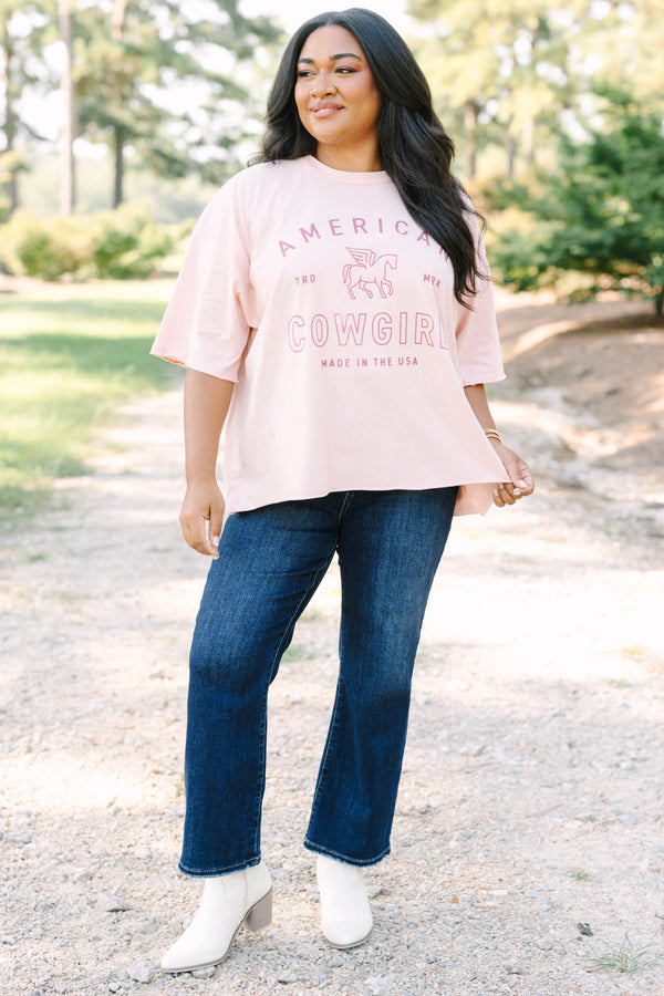 Plus Size blush pink vintage wash tee with an American Cowgirl graphic and unfinished hems.