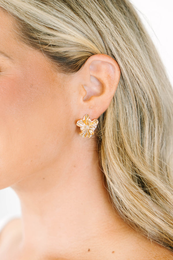 Gold flower-shaped earrings with textured petal details.