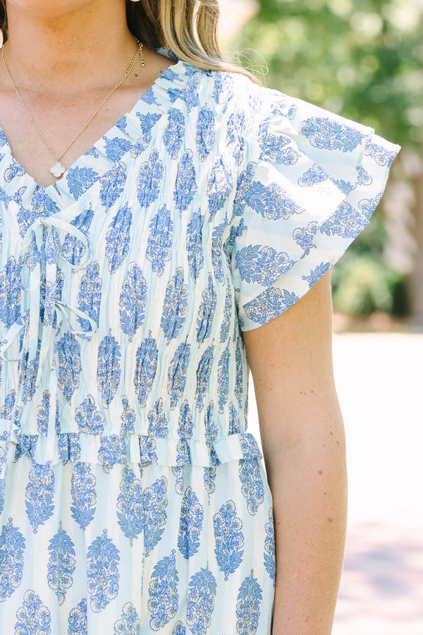 Plus Size blue and white patterned midi dress with flutter sleeves and a smocked bodice.