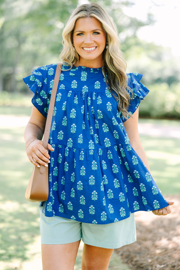 Plus Size navy blue tiered top with a green floral pattern, ruffle sleeves, and a high neckline.