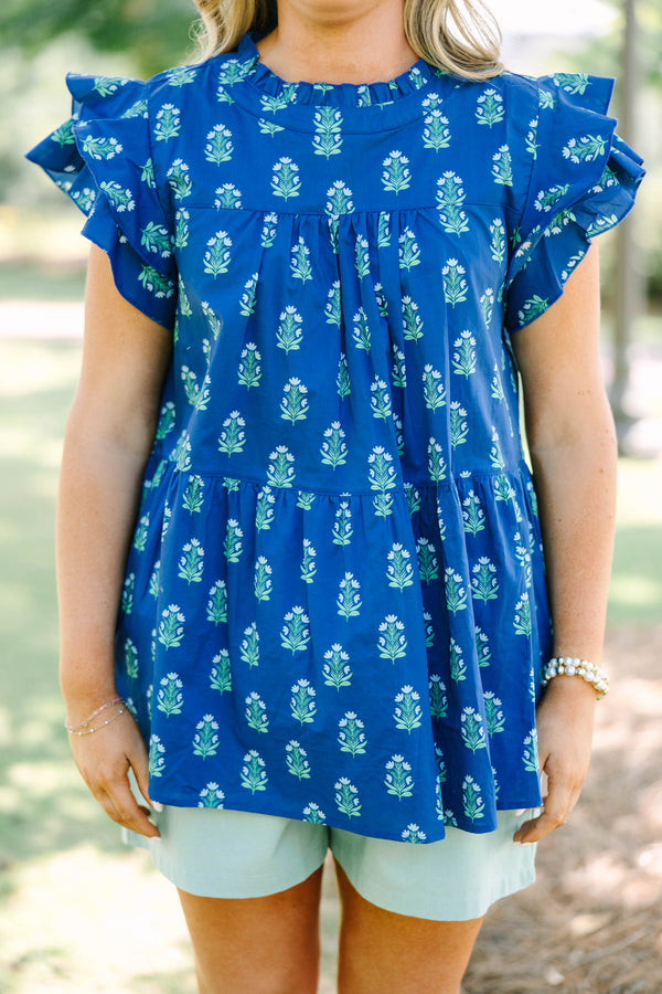 Plus Size navy blue tiered top with a green floral pattern, ruffle sleeves, and a high neckline.