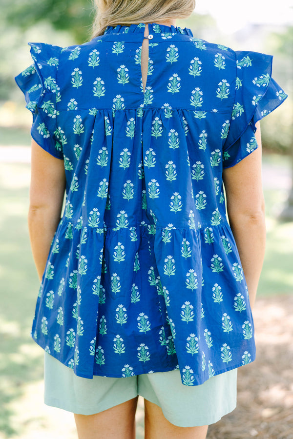 Plus Size navy blue tiered top with a green floral pattern, ruffle sleeves, and a high neckline.