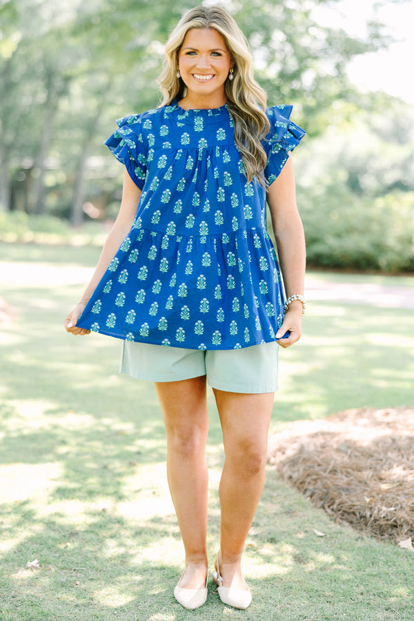 Plus Size navy blue tiered top with a green floral pattern, ruffle sleeves, and a high neckline.