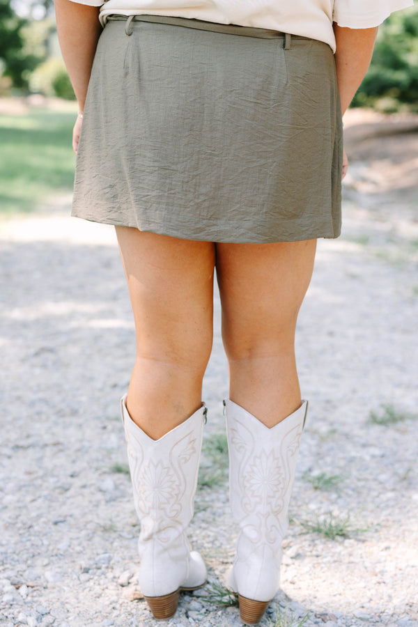 Plus Size olive green wrap-style skort with a side tie, paired with white embroidered cowboy boots.