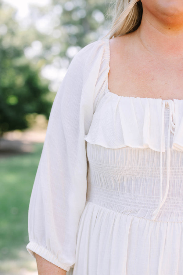 Plus Size cream midi dress with ruffle neckline, tiered bodice, and flowy three-quarter sleeves.