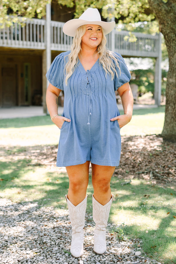 Plus Size denim romper with puff sleeves, a tie-front V-neckline, and pleated bodice details.
