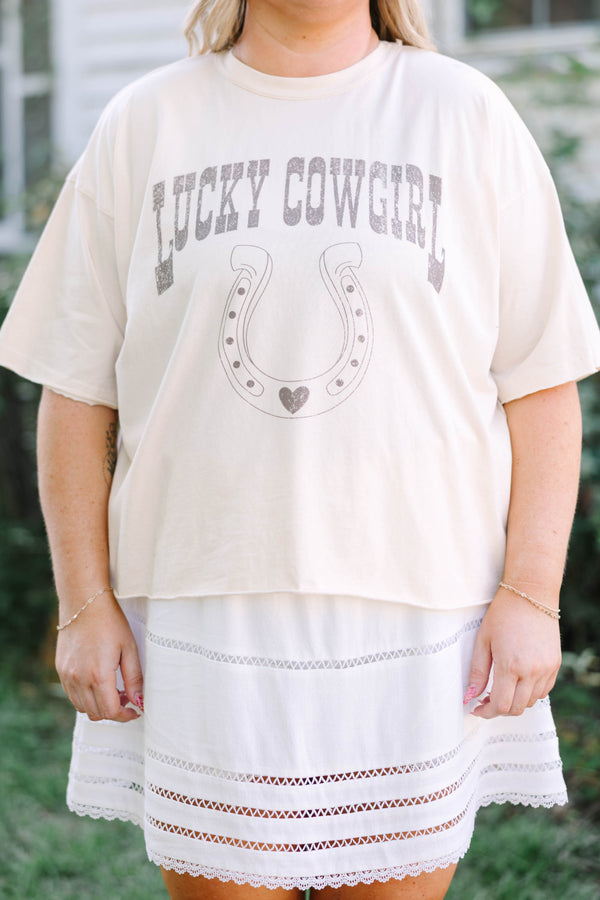 Plus Size sand vintage wash tee with a horseshoe graphic and a white eyelet mini skirt.