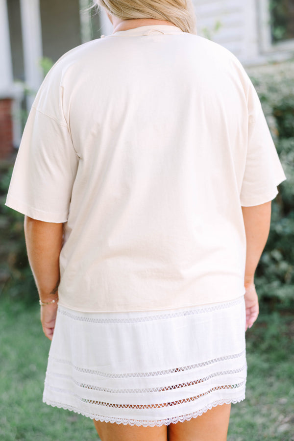 Plus Size sand vintage wash tee with a horseshoe graphic and a white eyelet mini skirt.