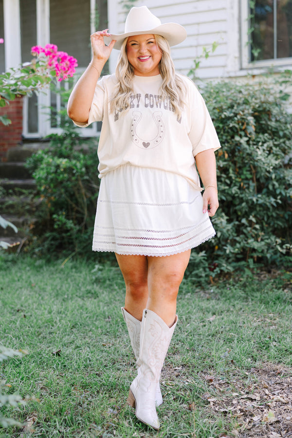 Plus Size sand vintage wash tee with a horseshoe graphic and a white eyelet mini skirt.