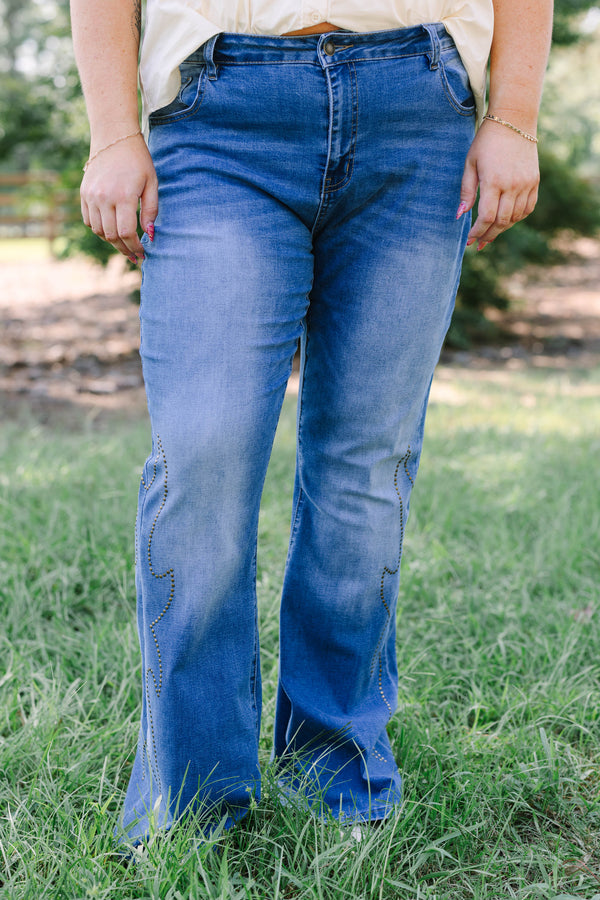 Plus Size medium wash flare jeans with studded embroidery along the outer side seams.