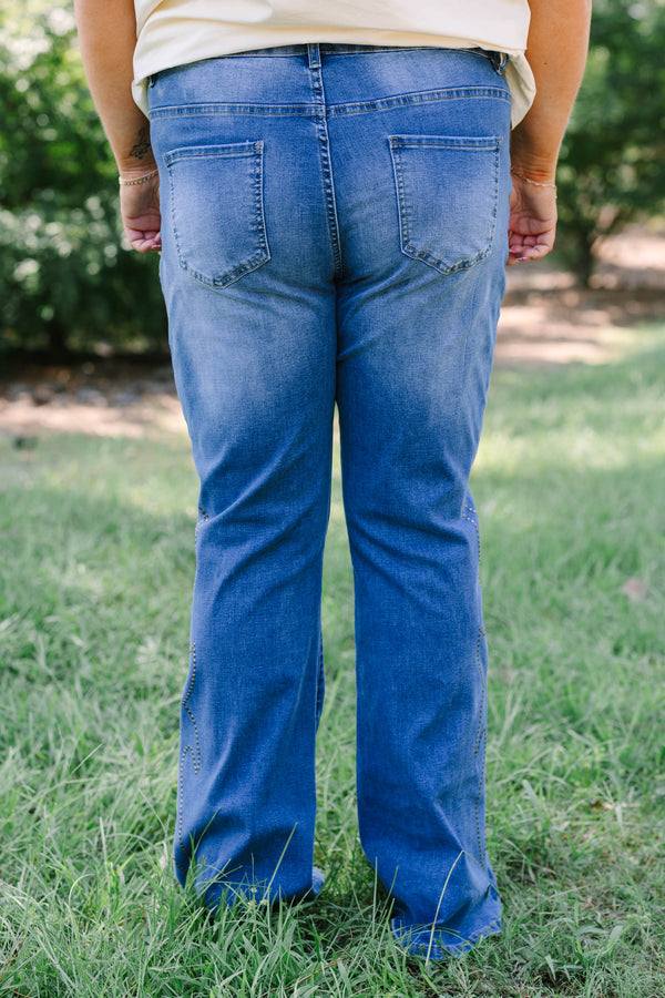 Plus Size medium wash flare jeans with studded embroidery along the outer side seams.