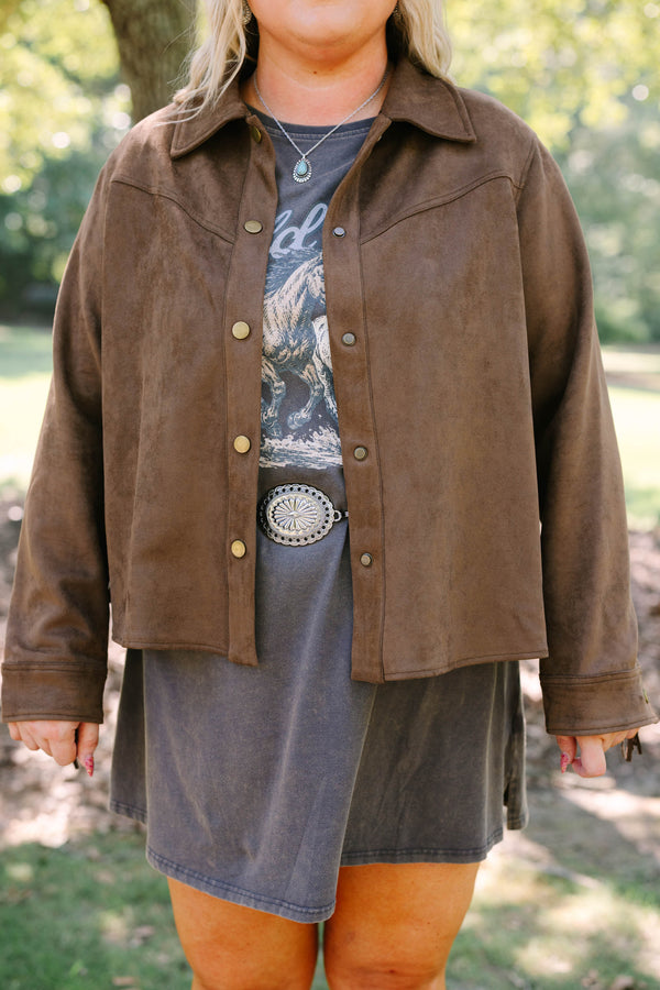 Plus Size brown suede-like jacket with fringe sleeves over a graphic tee and concho belt.