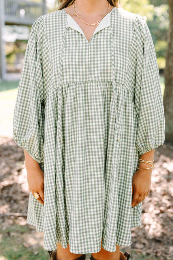 Plus Size green and white gingham babydoll dress with a v-neckline and three-quarter length sleeves.