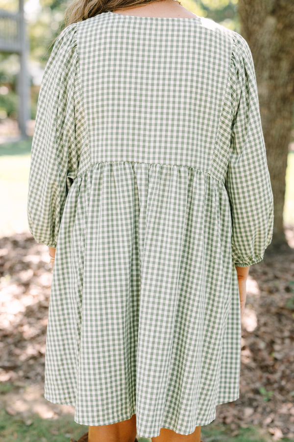 Plus Size green and white gingham babydoll dress with a v-neckline and three-quarter length sleeves.