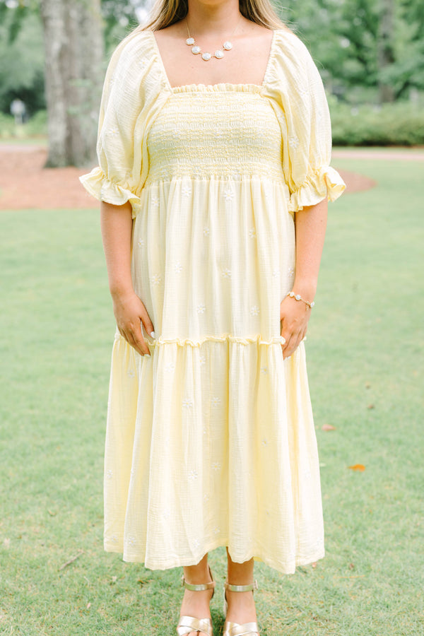Plus Size yellow midi dress with smocked bodice, puff sleeves, and white floral embroidery.