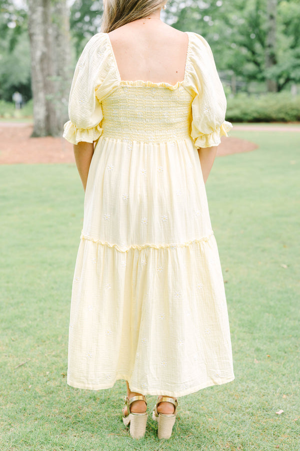 Plus Size yellow midi dress with smocked bodice, puff sleeves, and white floral embroidery.