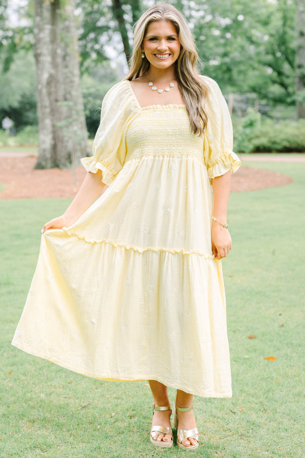 Plus Size yellow midi dress with smocked bodice, puff sleeves, and white floral embroidery.