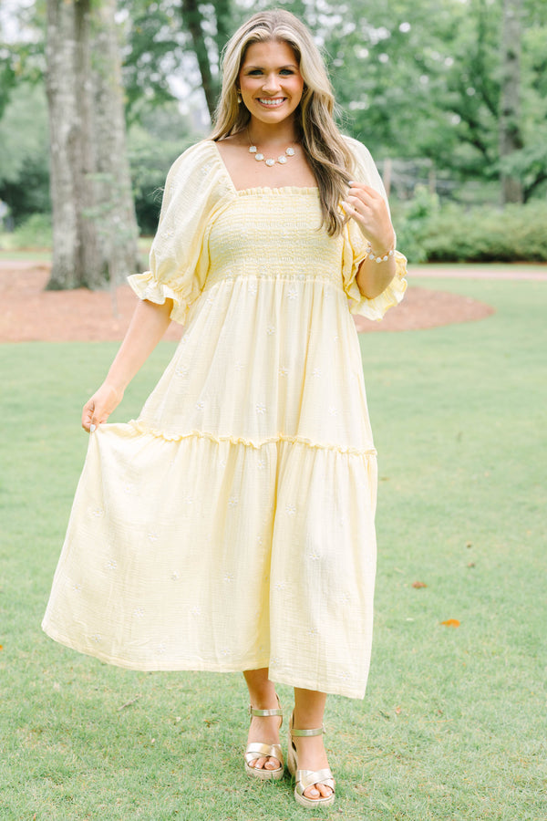 Plus Size yellow midi dress with smocked bodice, puff sleeves, and white floral embroidery.
