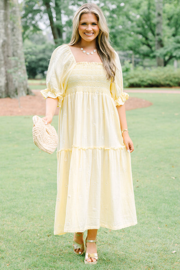 Plus Size yellow midi dress with smocked bodice, puff sleeves, and white floral embroidery.