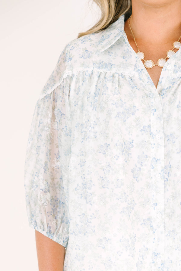 Plus Size blue and white floral button-down blouse with puff sleeves and a collared neckline.
