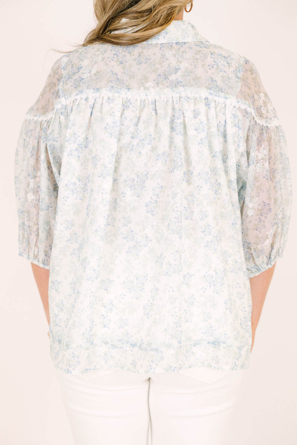 Plus Size blue and white floral button-down blouse with puff sleeves and a collared neckline.