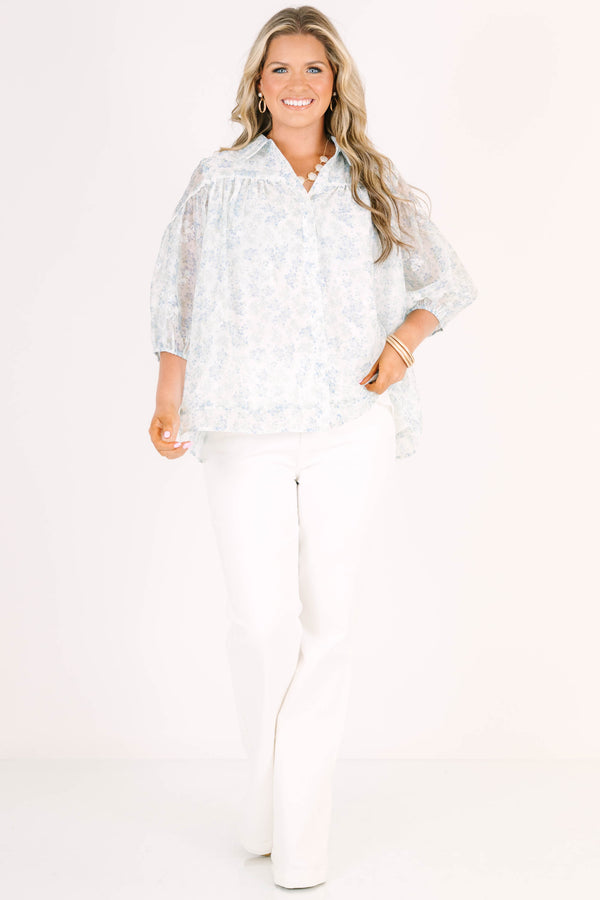 Plus Size blue and white floral button-down blouse with puff sleeves and a collared neckline.