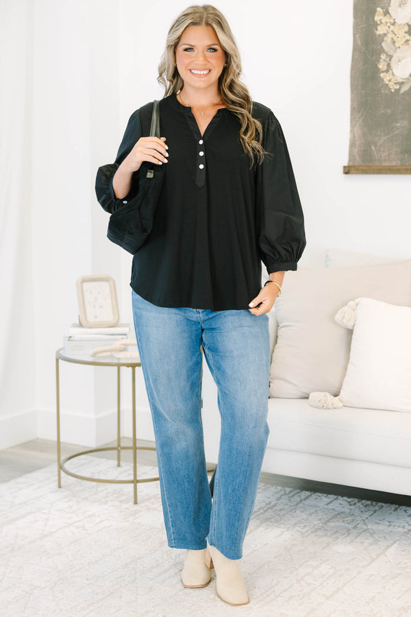 Plus Size black henley top with three-quarter puff sleeves, a button-up neckline, and a relaxed fit.