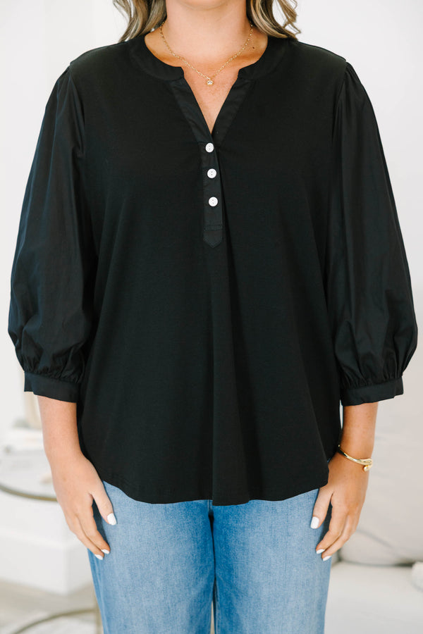 Plus Size black henley top with three-quarter puff sleeves, a button-up neckline, and a relaxed fit.
