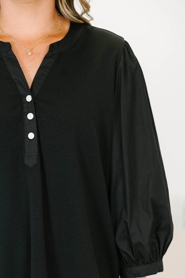 Plus Size black henley top with three-quarter puff sleeves, a button-up neckline, and a relaxed fit.