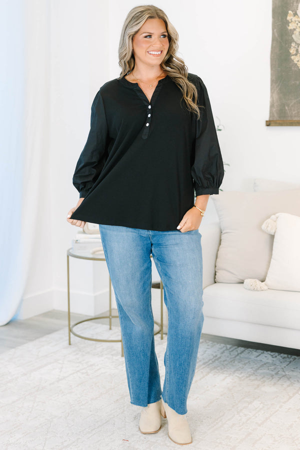 Plus Size black henley top with three-quarter puff sleeves, a button-up neckline, and a relaxed fit.