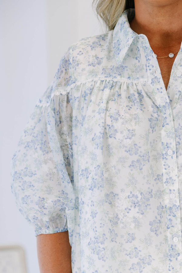 Plus Size blue and white floral button-down blouse with puff sleeves and a collared neckline.