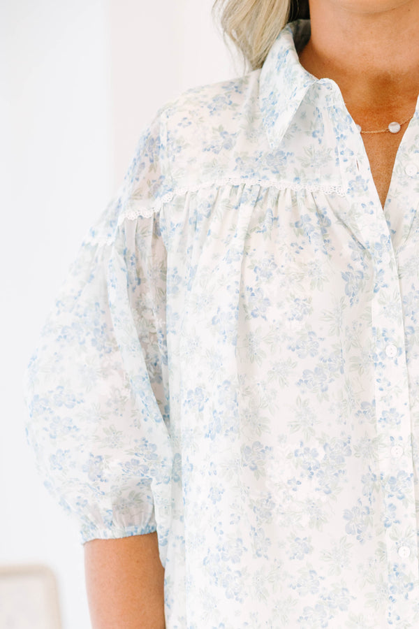 Plus Size blue and white floral button-down blouse with puff sleeves and a collared neckline.
