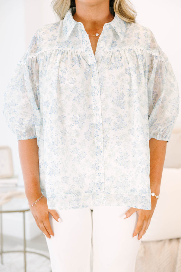 Plus Size blue and white floral button-down blouse with puff sleeves and a collared neckline.