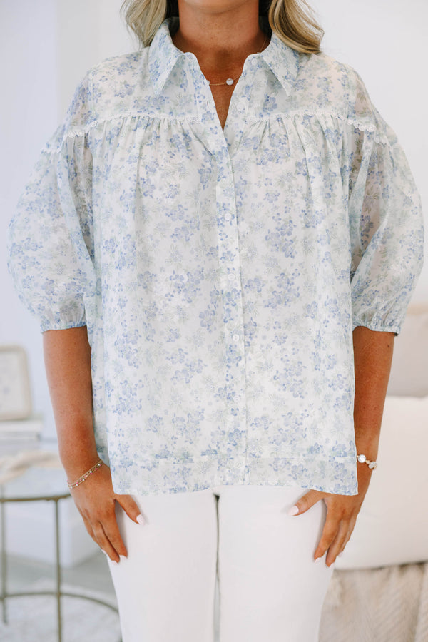 Plus Size blue and white floral button-down blouse with puff sleeves and a collared neckline.
