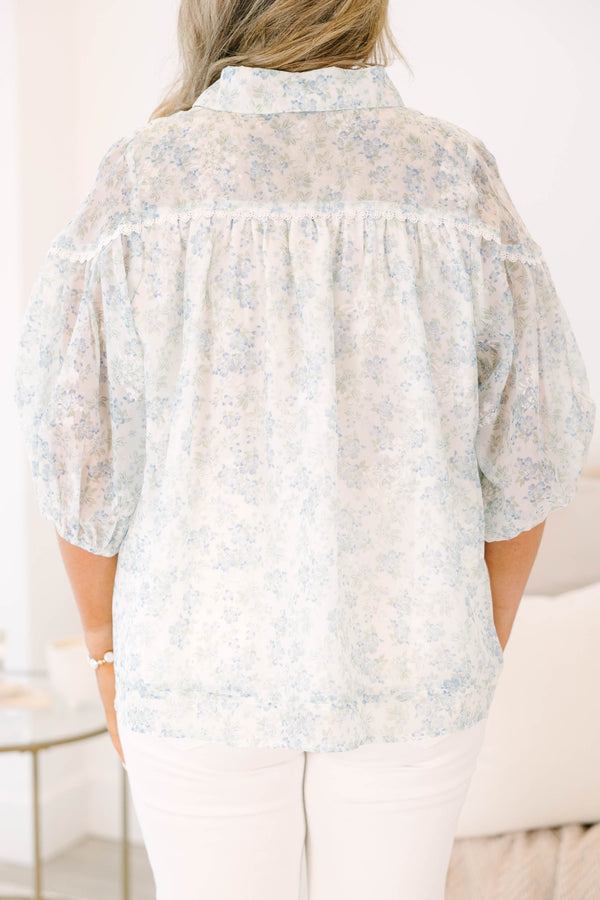 Plus Size blue and white floral button-down blouse with puff sleeves and a collared neckline.