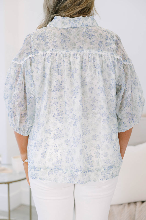 Plus Size blue and white floral button-down blouse with puff sleeves and a collared neckline.