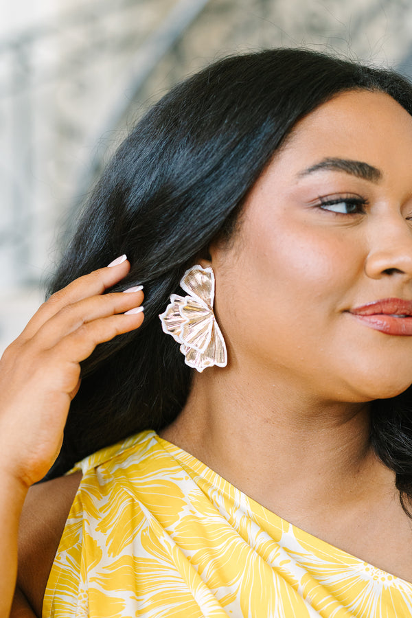 Plus Size gold fan-shaped statement earrings with white enamel trim and a textured metallic finish.
