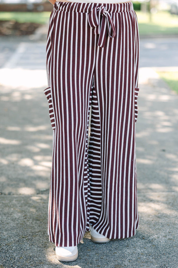 Plus size Be A Better You brown and white vertical stripe wide leg pants with a tie waist.