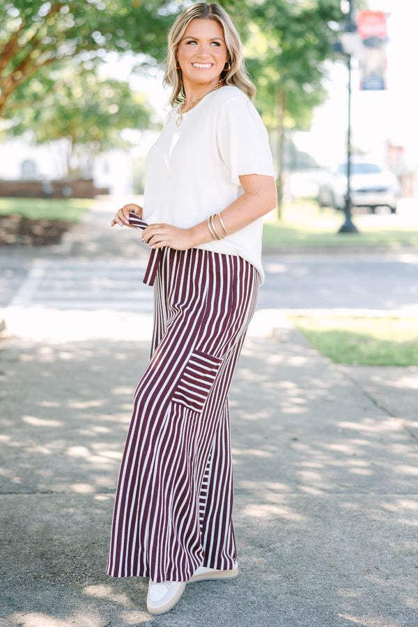 Plus size Be A Better You brown and white vertical stripe wide leg pants with a tie waist.