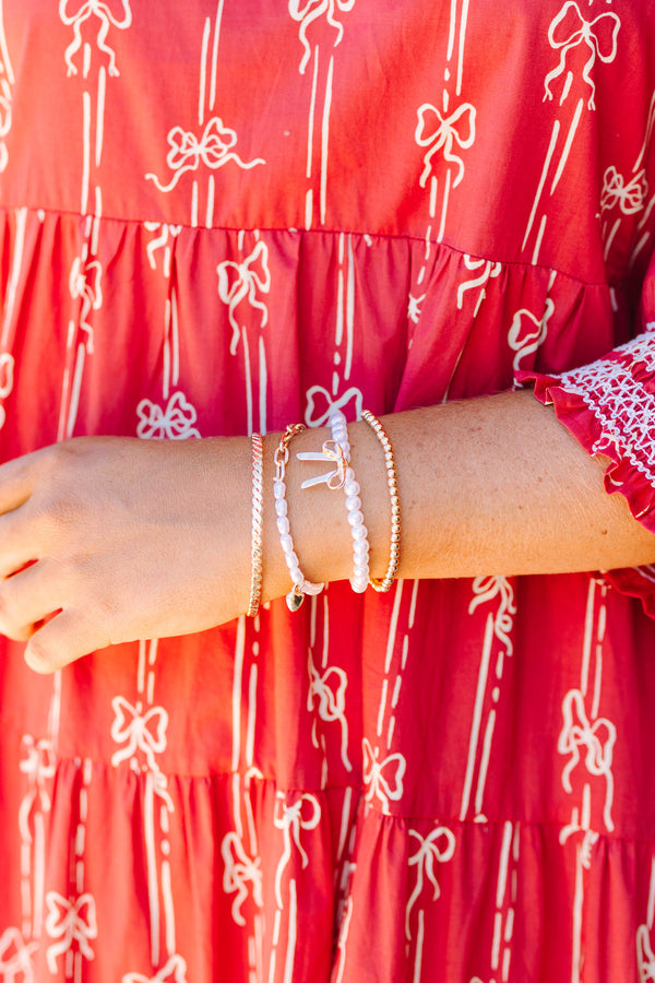 Plus Size gold-tone bracelet set with pearls, a bow charm, and a heart charm on a wrist.