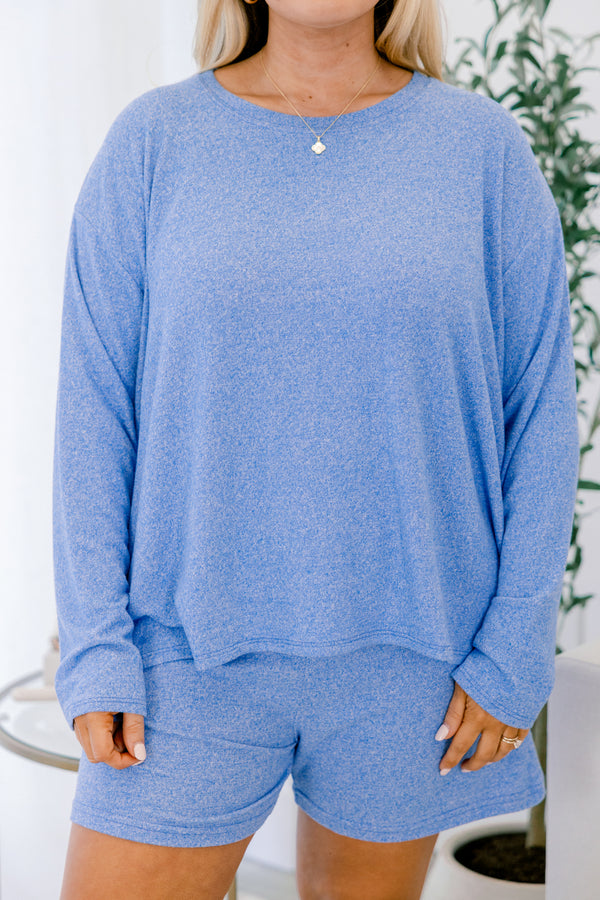 Person wearing a blue loungewear set with a white background