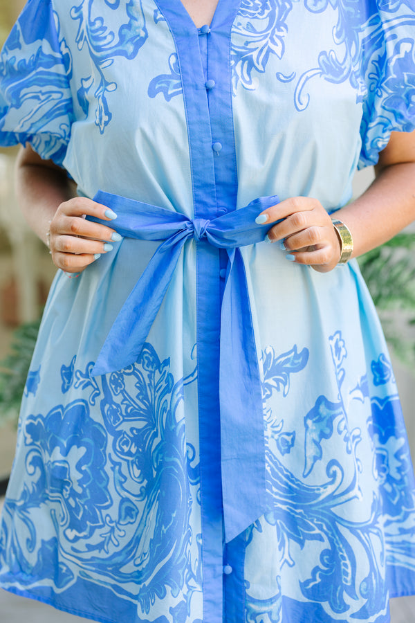 Plus Size blue mini dress with floral paisley print, puff sleeves, and a matching waist tie belt.