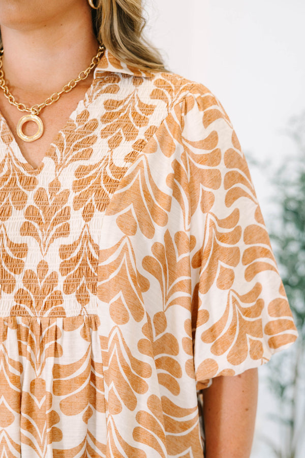 Plus Size tan and white patterned babydoll top with short sleeves and a smocked V-neckline.